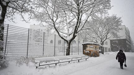 A pedestrian walks across a street during a snowy spring day in Vantaa, Finland, on April 23, 2024. Finland experienced exceptionally snowy weather for late April that caused chaos in commuter traffic, halted tramlines and delayed airport departures. - Fox Business News