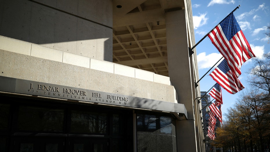 American flags wave outside the J. Edgar Hoover FBI Building in Washington, U.S., Dec. 2, 2020.