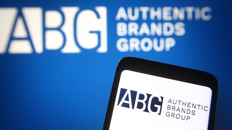 UKRAINE - 2021/05/29: In this photo illustration, Authentic Brands Group (ABG) logo seen on a smartphone and a pc screen in the background. (Photo Illustration by Pavlo Gonchar/SOPA Images/LightRocket via Getty Images)