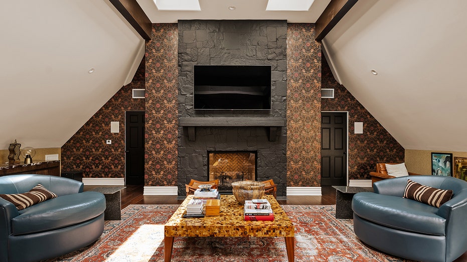 The finished attic boasts a wood-burning fireplace as well as a skylight and an accent wall.