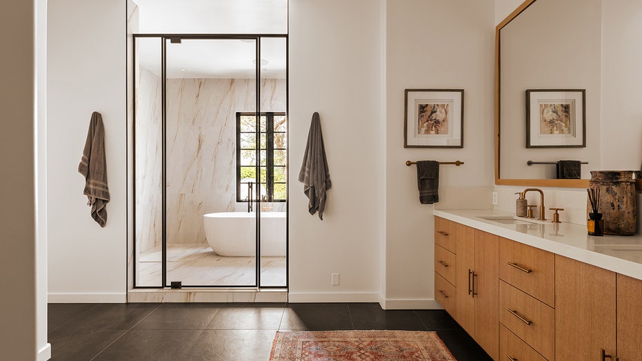 The esnuite bathroom features a soaking tub inside the standing shower.