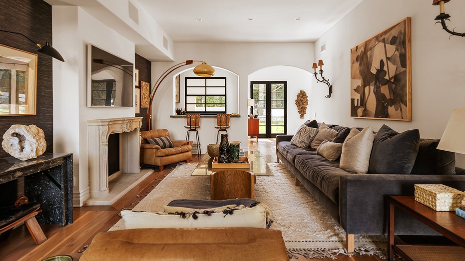 The family room features a limestone fireplace with a flat-screen TV hanging above it.
