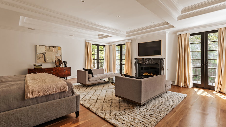 The primary bedroom features a private balcony and wood-burning fireplace.