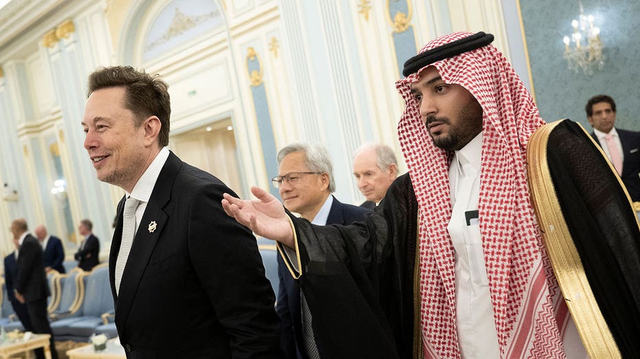 Senior Advisor to the US President Elon Musk (L) and Nvidia CEO Jensen Huang (C) are directed to greet the Saudi Crown Prince at the Royal Court in Riyadh on May 13, 2025. (Photo by Brendan Smialowski / AFP) (Photo by BRENDAN SMIALOWSKI/AFP via Getty Images)