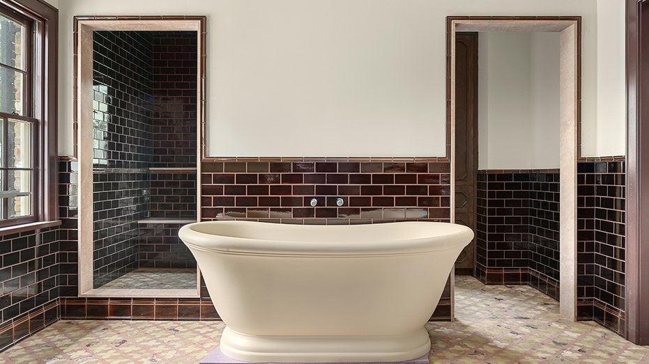 The bathroom features a soaking tub and a standing shower.