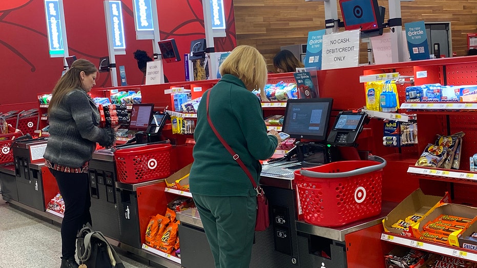 Customers using self checkout kiosks at Target