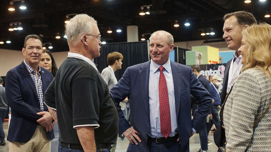 Greg Abel, chairman of Berkshire Hathaway Energy, center, during a shareholders shopping day ahead of the Berkshire Hathaway annual meeting in Omaha, Nebraska, U.S., on Friday, April 29, 2022. After hanging in the shadows for most of the pandemic, Warren Buffett and his deputies have been ramping up Berkshire Hathaway Inc.s acquisition machine -- snapping up shares of Occidental Petroleum Corp. and HP Inc. and striking an $11.6 billion deal to buy Alleghany Corp. Photographer: Dan Brouillette/Bloomberg via Getty Images