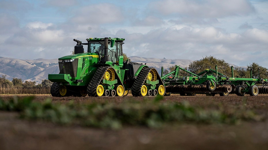 John Deere autonomous 9RX tractor in field 