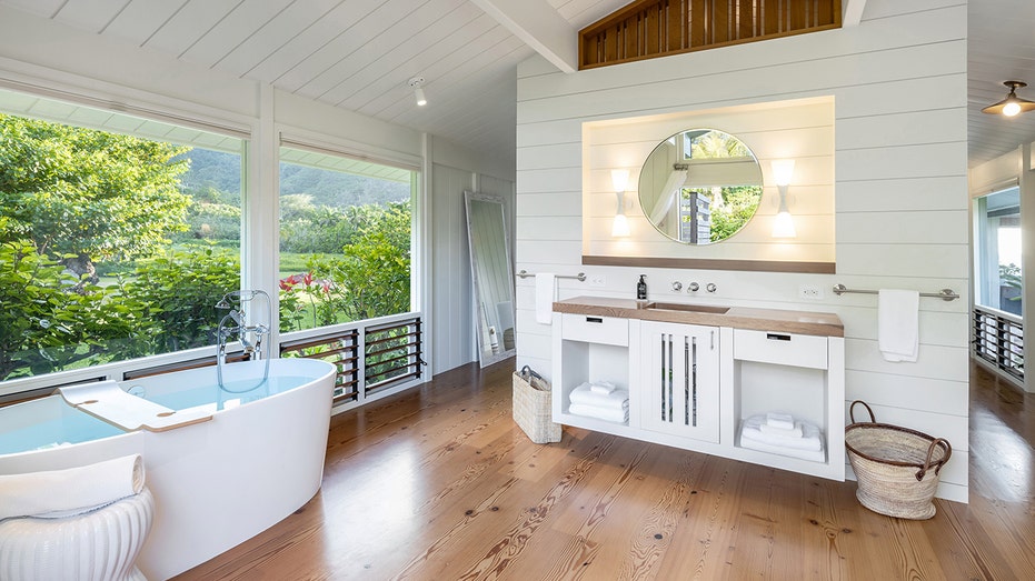 ensuite bathroom featuring a soaktub