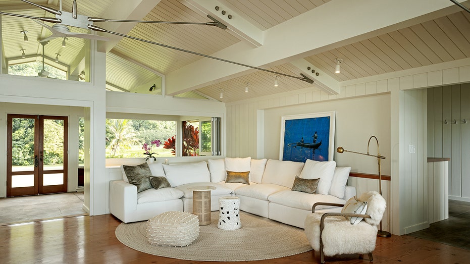 The living room features a wood-paneled cathedral ceiling. 