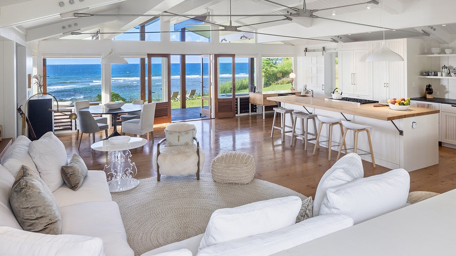 The kitchen and living room also features a small dining area, in front of floor-to-ceiling windows looking out onto the ocean.
