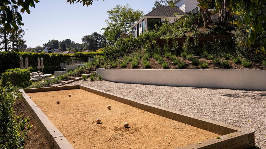 The backyard also features a bocce ball court.