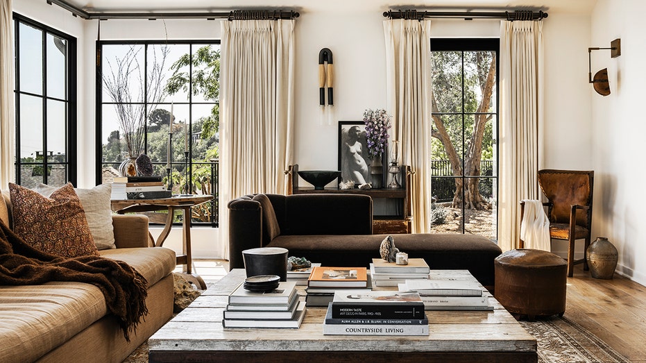 The living room features a wood-burning fireplace and floor-to-ceiling windows.