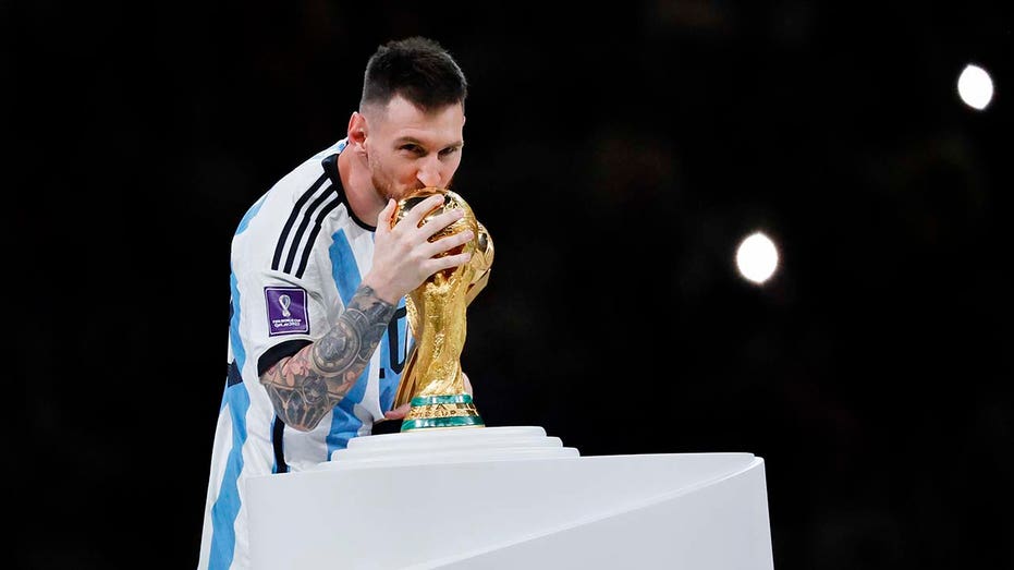 Lionel Messi kisses the trophy