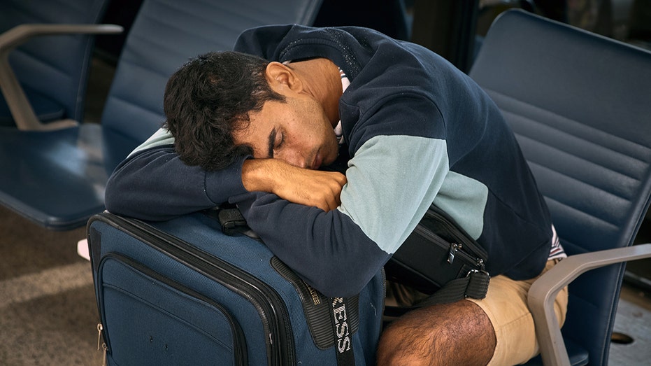 Passenger sleeps at Newark amid delays