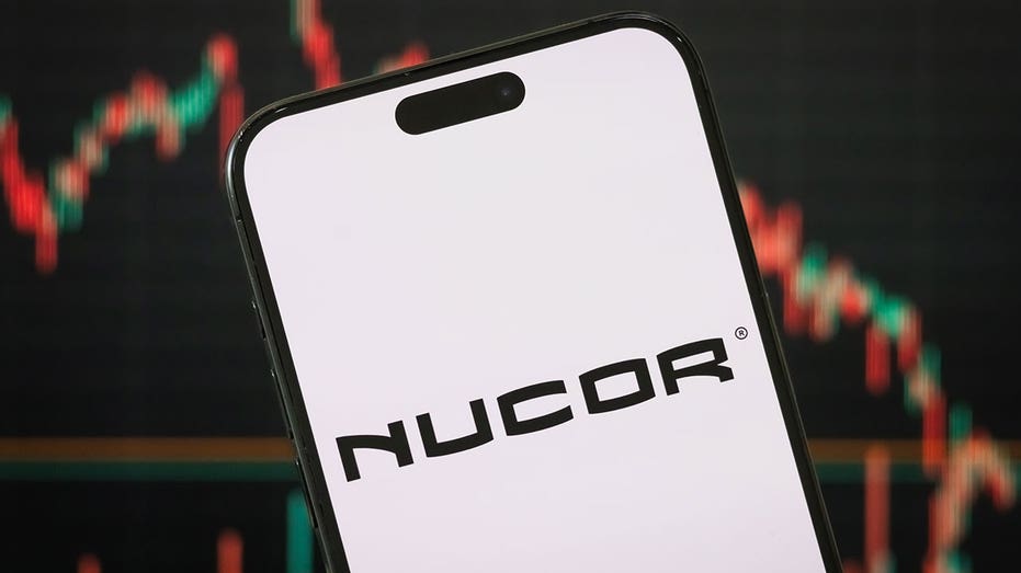CHONGQING, CHINA - APRIL 23: In this photo illustration, the logo of Nucor Corporation is displayed on a smartphone screen, with a stock market chart in the background, reflecting investor sentiment and trading dynamics, on April 23, 2025, in Chongqing, China. Nucor is the largest steel producer in the United States and a major player in the North American steel industry, known for its electric arc furnace technology and sustainable steelmaking practices. (Photo illustration by Cheng Xin/Getty Images)