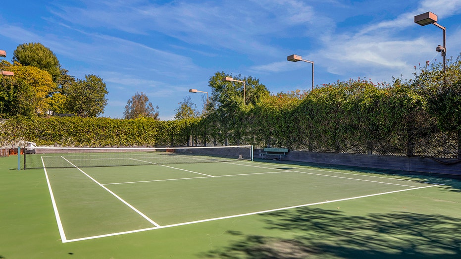 The grounds also feature a tennis court.