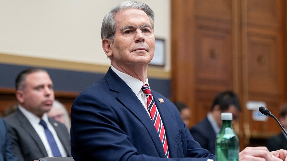 Treasury Secretary Scott Bessent wearing a red tie and dark suit as he testifies at a House hearing