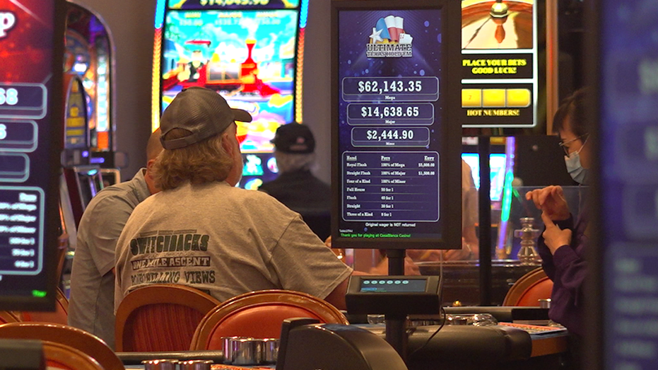 A man sitting at a game table in the casino