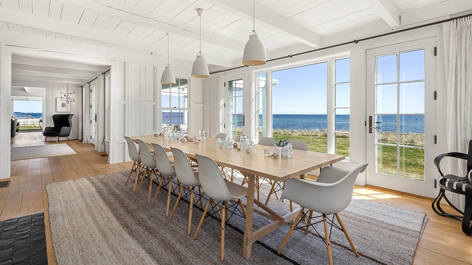 The dining room features a wood burning fireplace and a large table that suits 12.