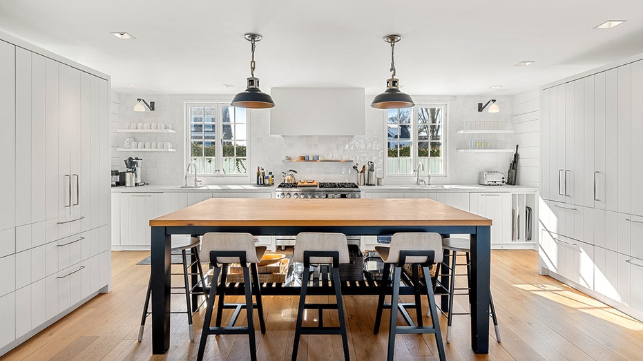 The kitchen features a large central island, custom tanks and a dual oven.