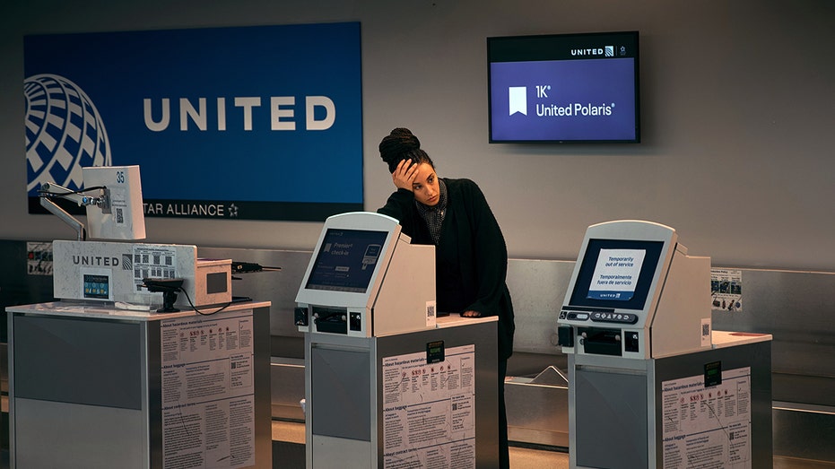 Newark Airport United employee with head in hand