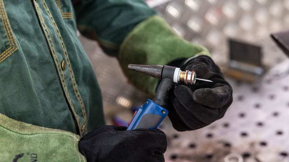 19 January 2025, Brandenburg, Cottbus: A man is busy assembling a TIG torch for his welding work at the stand of a metal construction company at the trade fair. Photo: Frank Hammerschmidt/dpa (Photo by Frank Hammerschmidt/picture alliance via Getty Images)