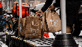 A delivery worker picks up Wegmans bags outside a store in New York, US, on Thursday, Aug. 8, 2024. - Fox News