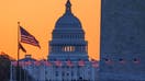 WASHINGTON, DC - MARCH 23: Sunrise turns the sky orange behind the U.S. Capitol building as it illuminates the U.S. Flags circling the base of the Washington Monument on March 23, 2025, in Washington, DC.  - Fox Business News