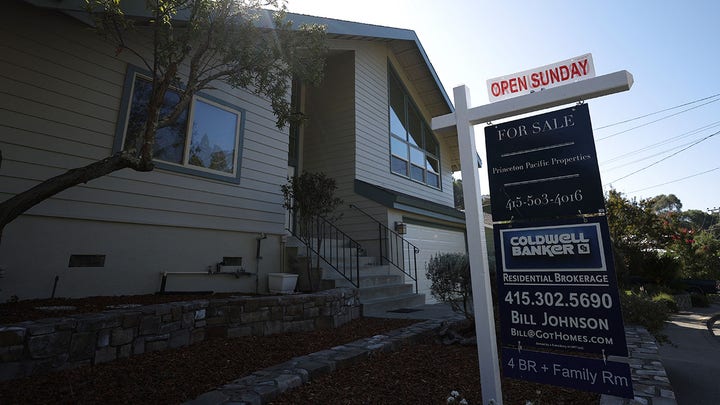 Real estate sign indicating homes for sale