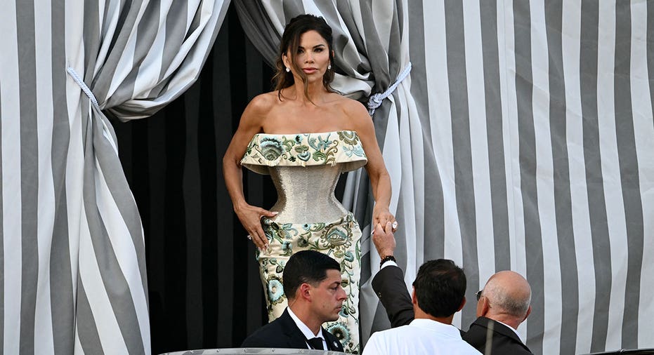 Amazon founder Jeff Bezos and Lauren Sanchez get on a taxi boat at the Aman Hotel in Venice on June 26, 2026. Celebrities in superyachts sail into Venice this week for the three-day wedding party of Amazon tycoon Jeff Bezos and Lauren Sanchez, despite irate locals who say the UNESCO city is no billionaire's playground. The tech magnate and journalist have reportedly invited about 200 guests to their multi-million dollar nuptials in the Italian city, which are expected to kick off on June 26 and end Saturday with a ceremony at a secret location. (Photo by Stefano Rellandini / AFP) (Photo by STEFANO RELLANDINI/AFP via Getty Images)