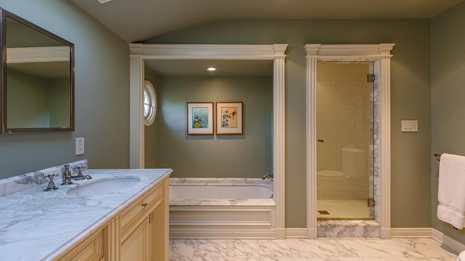 A third ensuite bathroom features a bathtub and a standing shower.