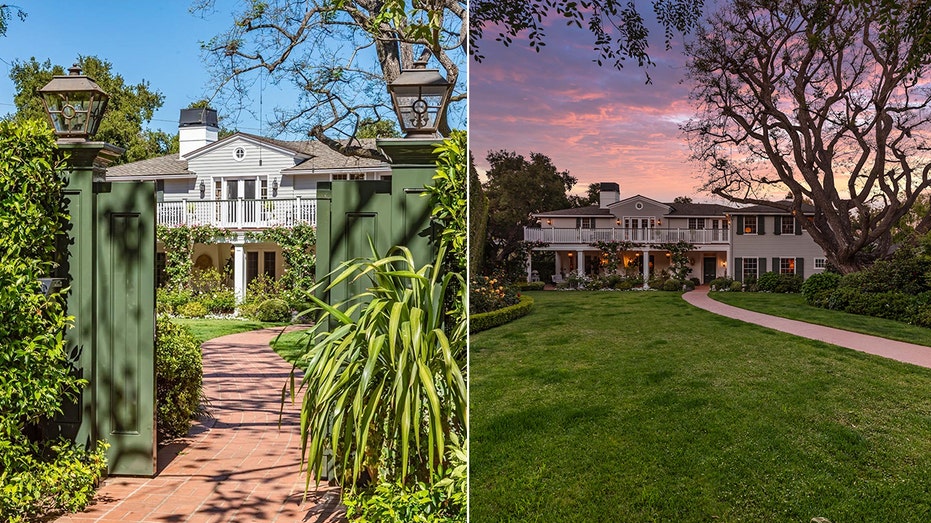 A brick path leads to a gray wood-paneled home with white windows and green shutters.