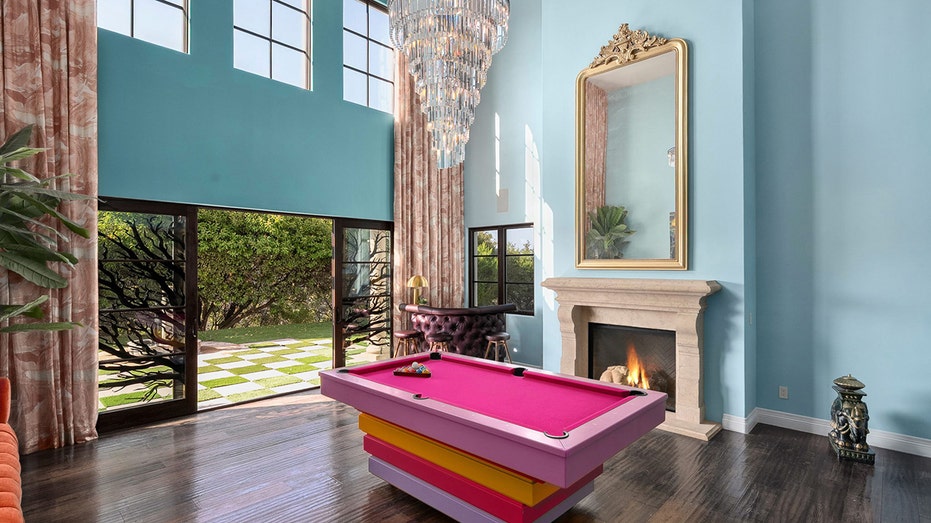 The great room features high ceilings and a wood-burning fireplace.