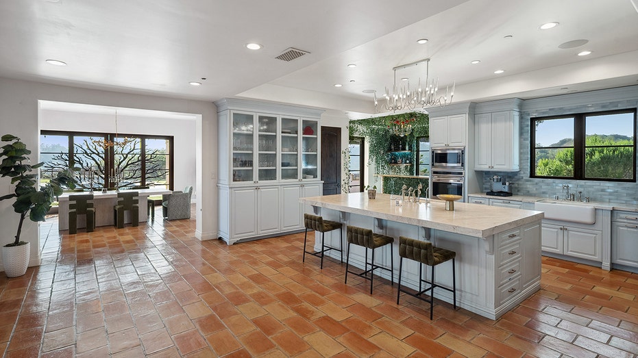 The kitchen features an eat-in center island and plenty of counter space.