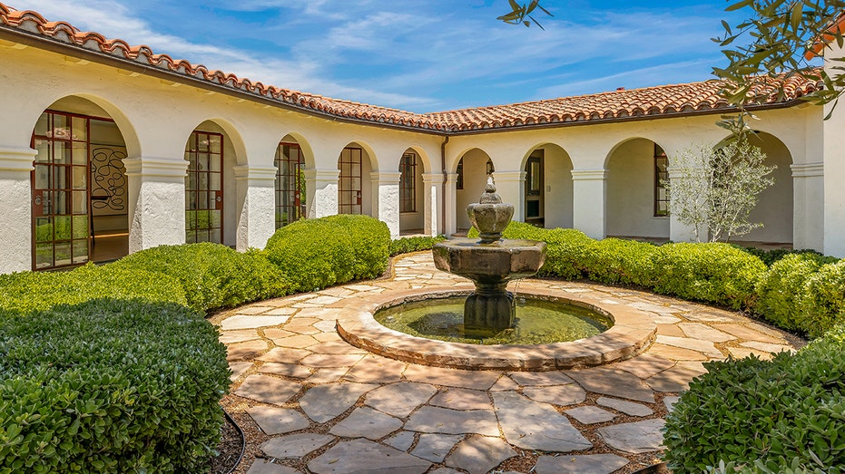 A courtyard featuring a fountain is also found in the front yard.