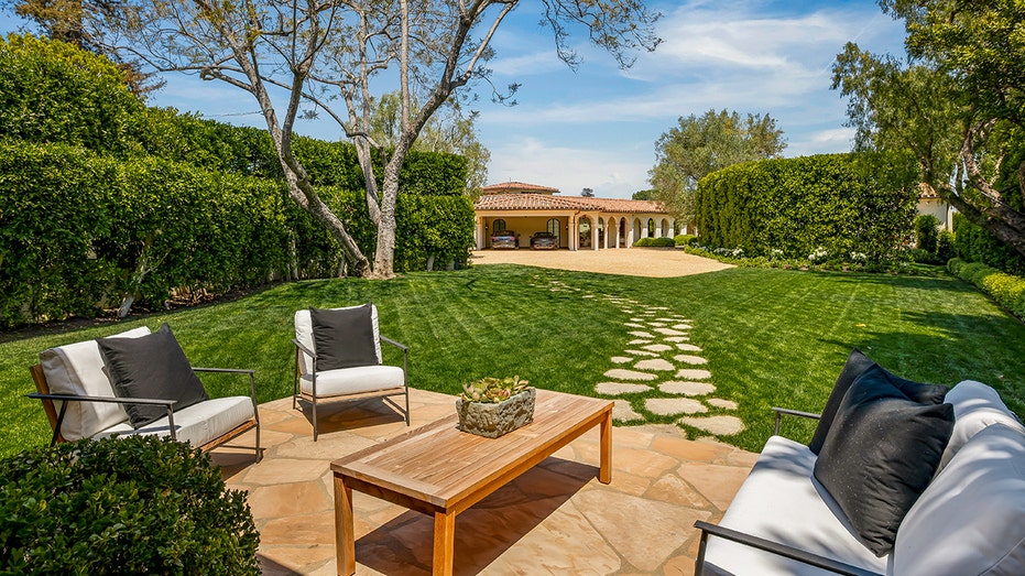 A seating area can be found a short distance from the carport.