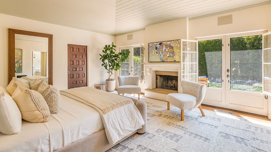 The primary bedroom features a wood-burning fireplace and access to the yard.