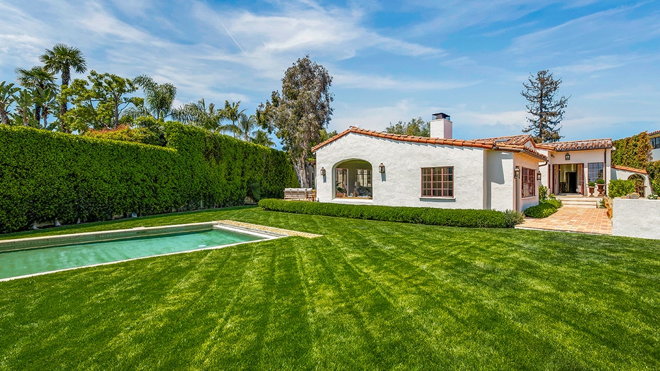 The pool is surrounded by grass on all sides.