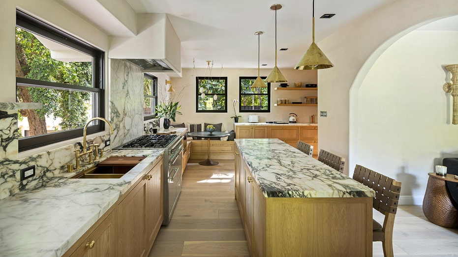 The kitchen features an eat-in center island, built-in shelves and a breakfast nook.