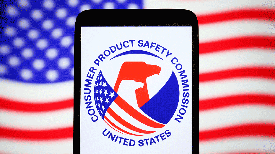 UKRAINE - 2023/05/13: In this photo illustration, a United States Consumer Product Safety Commission (CPSC) logo is seen on a smartphone and the U.S. flag on a pc screen. (Photo Illustration by Pavlo Gonchar/SOPA Images/LightRocket via Getty Images)