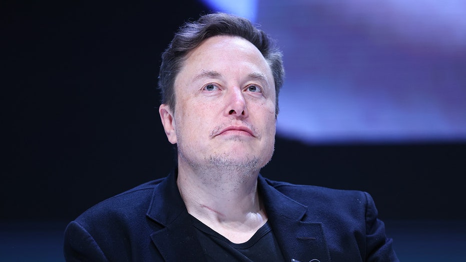 Elon Musk wearing a jacket