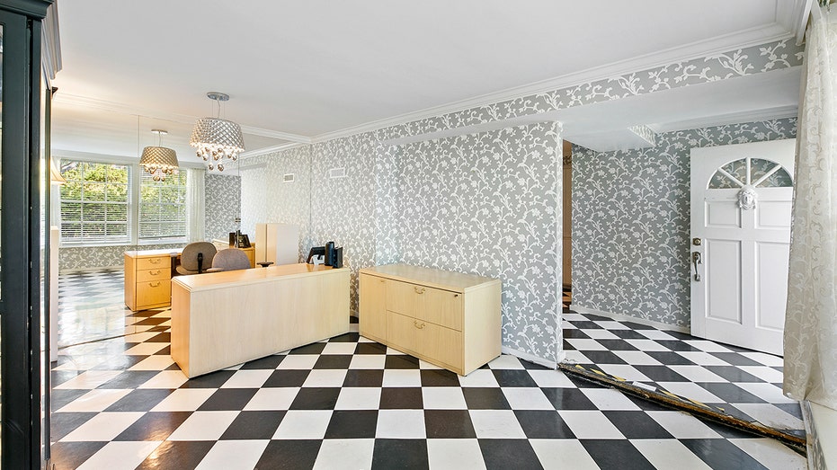The property also includes a potential guest house with black and white checkered floors.