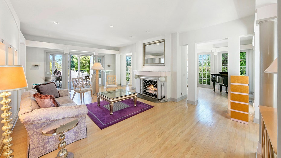 The living room features a wood-burning fireplace and access to the backyard.
