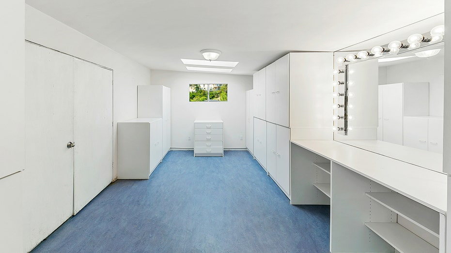 The pool house features a vanity and built-in shelves.