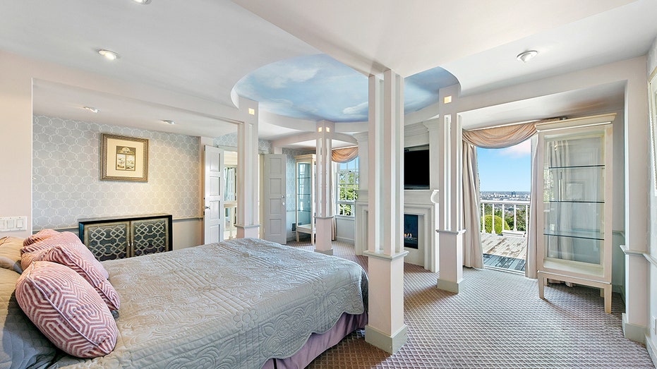 The primary bedroom features a wood-burning fireplace and access to an outdoor terrace.