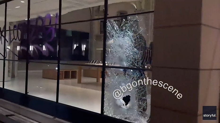 massive hole in glass window of apple store