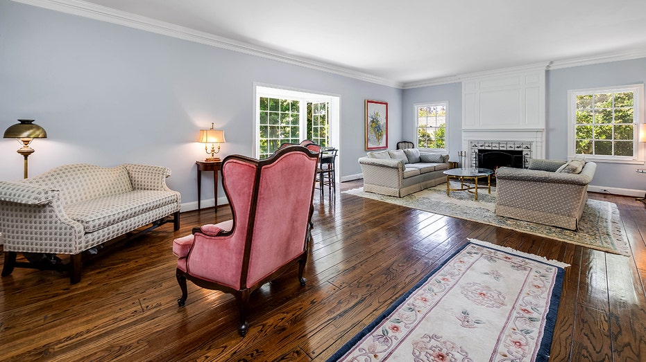 The living room features blue walls, a wood-burning fireplace and a door leading to the backyard.