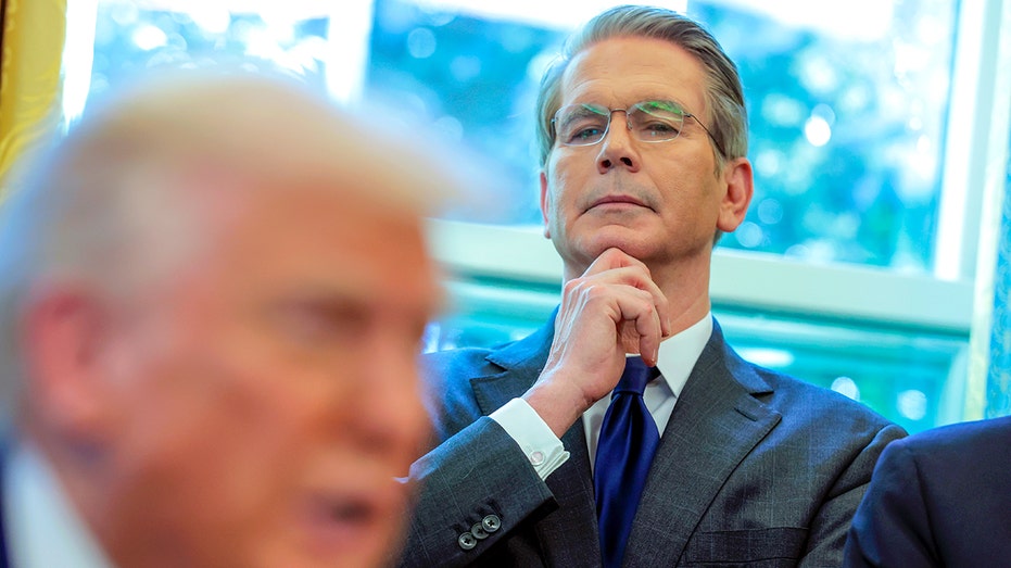 Scott Bessent stands behind Donald Trump
