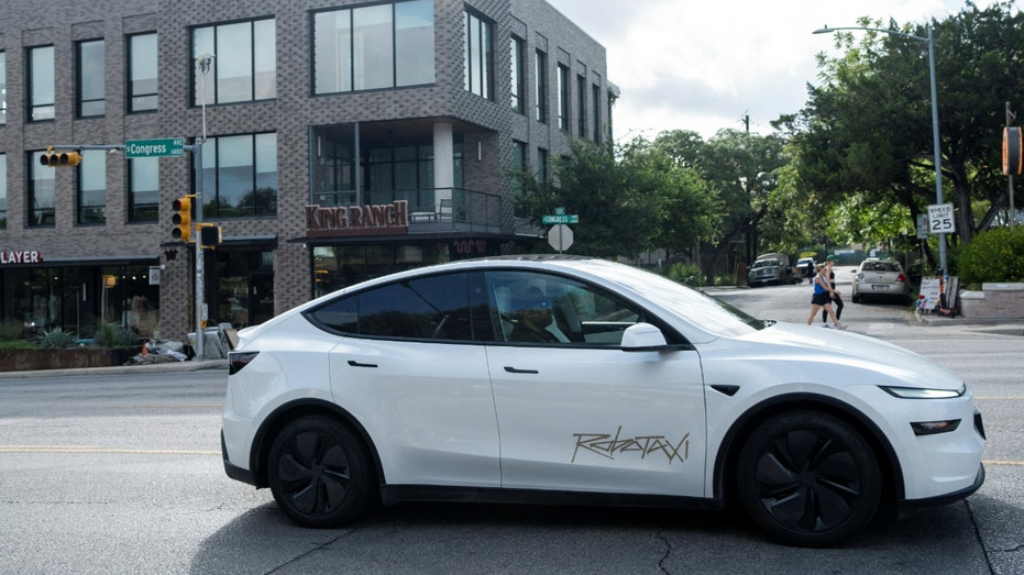A Tesla robotaxi drives on the street along South Congress Avenue in Austin, Texas, on June 22, 2025.